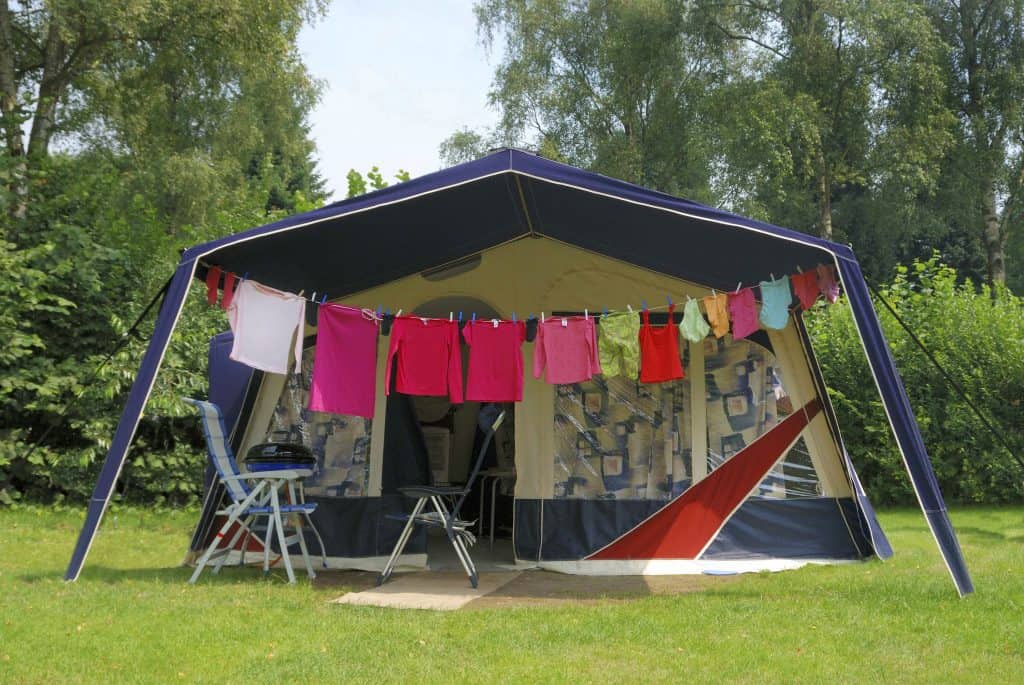 Photo of Tent at camping with cleaned and washed clothes in front