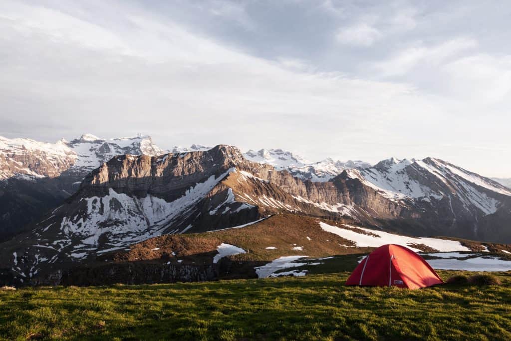 Photo of A tent behind a magnificent mountain