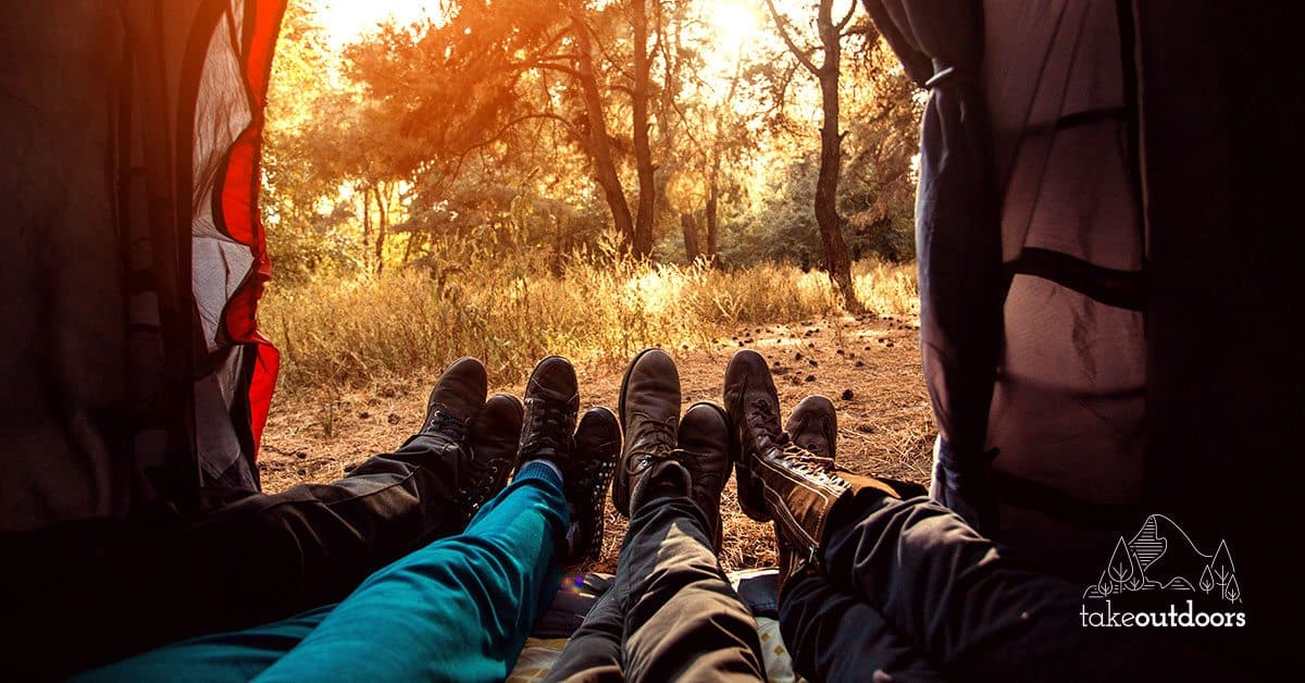 Inside a tent with 3 people squeezing with their legs out
