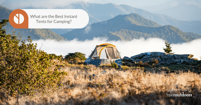 Photo of a tent in the middle of a scenic highland with a view of mountains behind